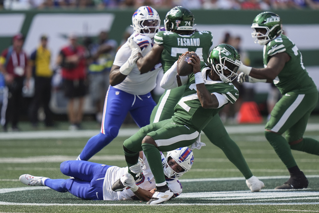 New York Jets quarterback Tyrod Taylor (2) is sacked by Buffalo Bills safety Cole Bishop (24) during the fourth quarter of an NFL football game, Sunday, Sept. 14, 2025, in East Rutherford, N.J. (AP Photo/Frank Franklin)
