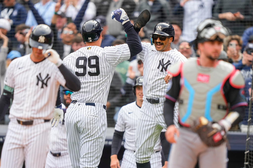New York Yankees' Aaron Judge (99) celebrates with Trent Grisham (12) after hitting a two-run home run during the first inning of the Yankees' home-opener baseball game against the Miami Marlins, Friday, April 3, 2026, in New York. (AP Photo/Yuki Iwamura)