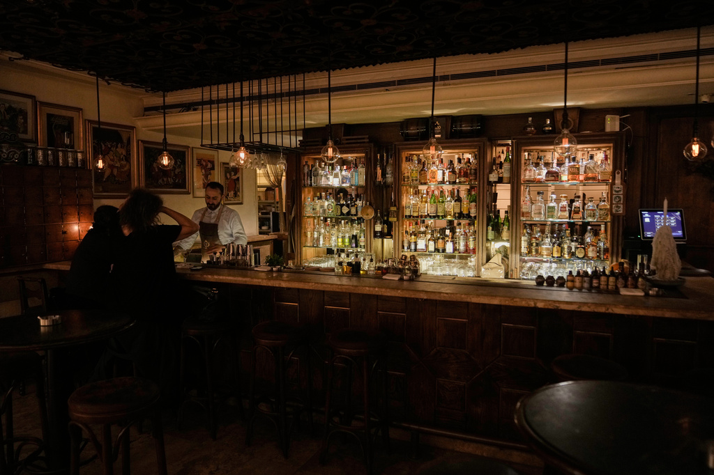 People spend time at an almost empty bar on Hamra Street in Beirut, May 5, 2026. (AP Photo/Bilal Hussein)