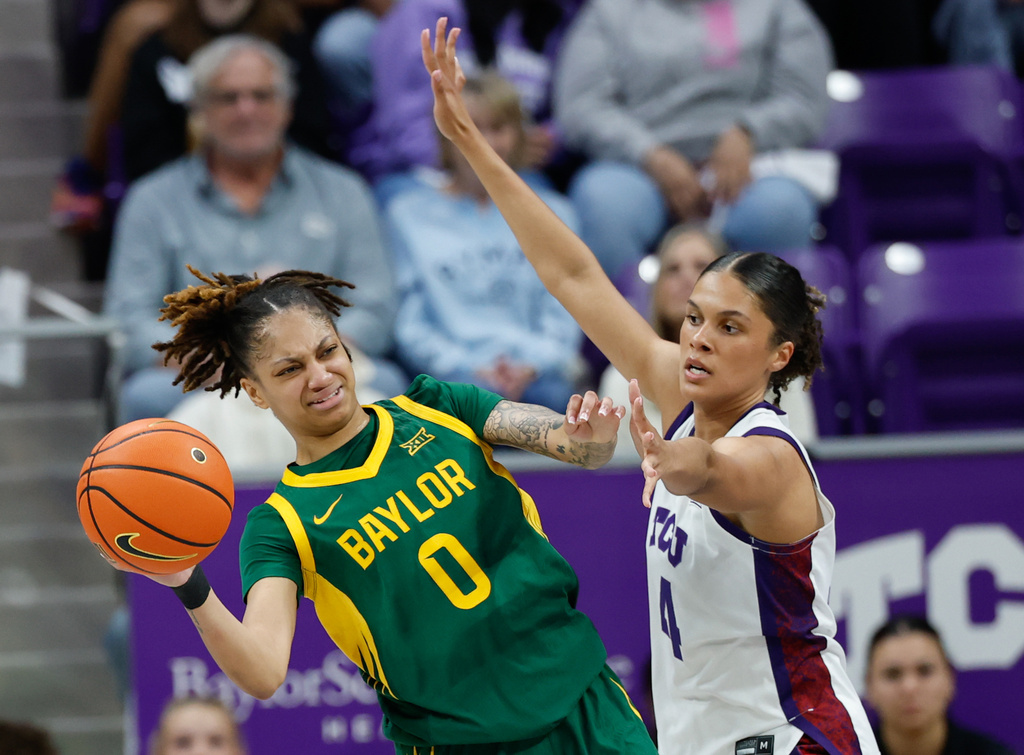 Baylor guard Taliah Scott looks to pass against TCU guard Donovyn Hunter during the first half of an NCAA college basketball game, Sunday, March 1, 2026, in Fort Worth, Texas. (Chris Jones/Waco Tribune-Herald, via AP)