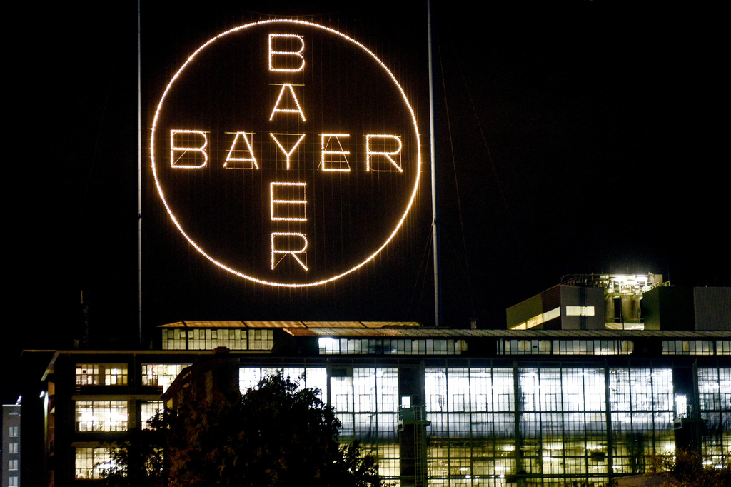 FILE - The Bayer logo shines at night at the main chemical plant of German Bayer AG on Aug. 9, 2019, in Leverkusen, Germany. (AP Photo/Martin Meissner, File)