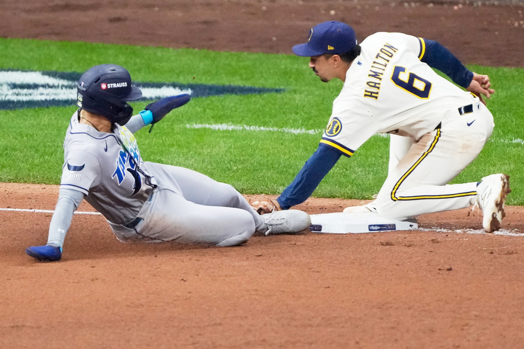 Tampa Bay Rays' Victor Mesa Jr. is tagged out stealing by Milwaukee Brewers third baseman David Hamilton during the fifth inning of Game 1 of baseball's World Series, Friday, Oct. 23, 2026, in Milwaukee, between the Milwaukee Brewers and the Tampa Bay Rays. (AP Photo/David J. Phillip)