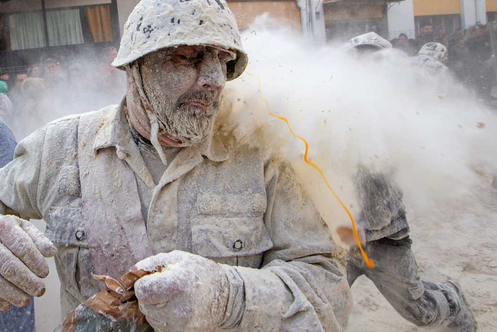 Revellers take part in the Els Enfarinats festival, a battle using flour, eggs and firecrackers, in the town of Ibi near Alicante, Spain, Sunday Dec. 28, 2025. (AP Photo/Alberto Saiz)