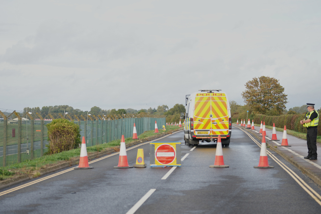 Police guard a road leading to RAF Fairford, a US Airbase, after an incident in Fairford, England , Sunday, Sept. 27, 2026. (AP Photo/Alastair Grant)