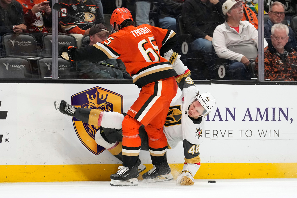 Vegas Golden Knights right wing Jonas Rondbjerg, right, falls after being hit by Anaheim Ducks defenseman Jacob Trouba during the second period of an NHL hockey game Sunday, Feb. 1, 2026, in Anaheim, Calif. (AP Photo/Mark J. Terrill)