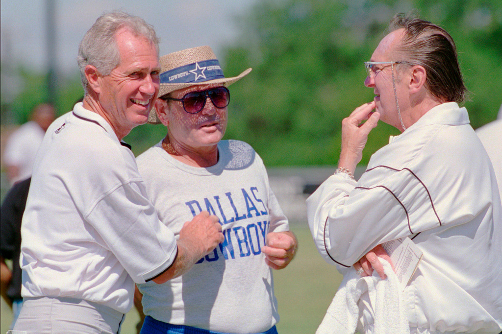 FILE - Oakland Raiders head football coach Mike White, left, speaks with Dallas Cowboys offensive coordinator Ernie Zampese, and Raiders owner Al Davis, right, after the teams worked out, in Austin, Texas, Aug. 1, 1995. (AP Photo/Harry Cabluck, File)