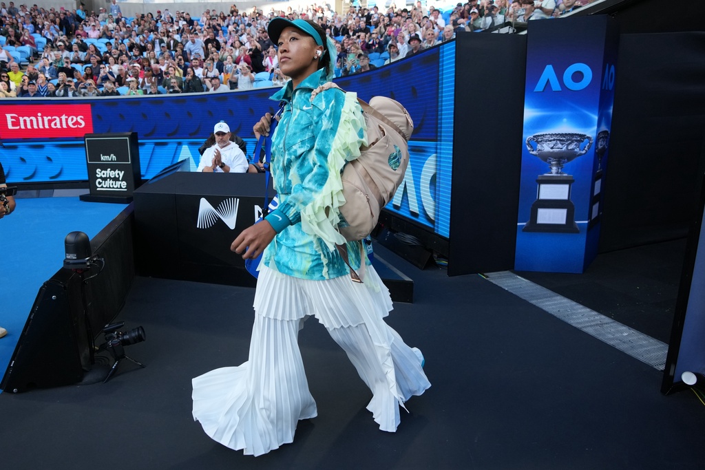Naomi Osaka of Japan walks onto court for her second round match against Sorana Cirstea of Romaniaat the Australian Open tennis championship in Melbourne, Australia, Thursday, Jan. 22, 2026. (AP Photo/Dita Alangkara)