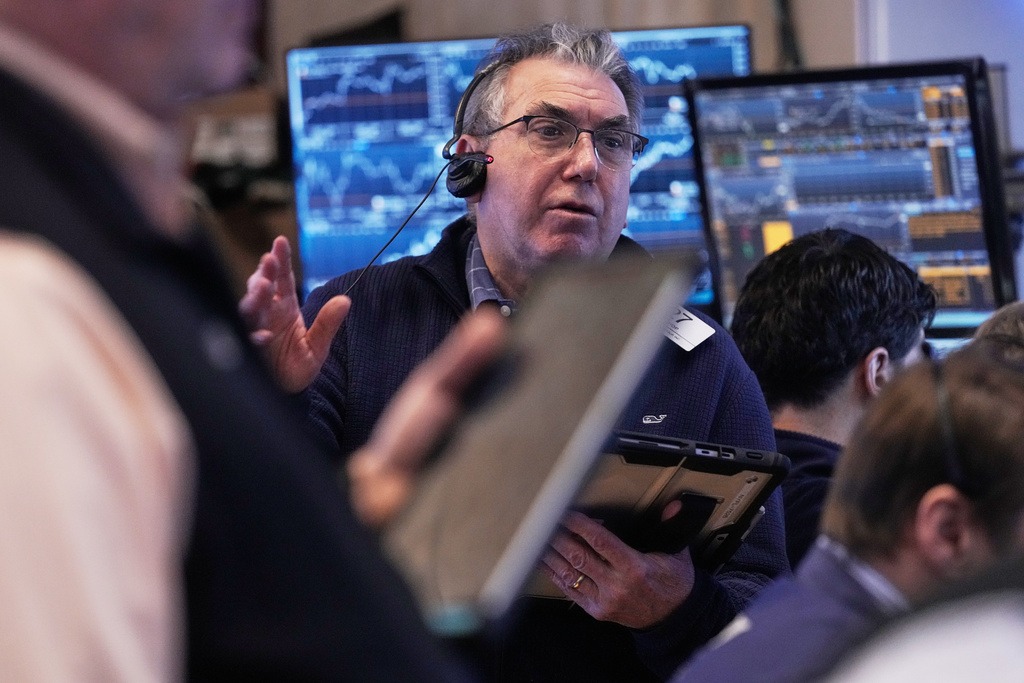 Trader John Bishop works on the floor of the New York Stock Exchange, Friday, Feb. 20, 2026. (AP Photo/Richard Drew)
