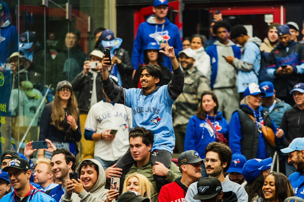 Toronto Blue Jays fans celebrate after the team beat the Seattle Mariners to win the American League Championship Series in Toronto, Monday, Oct. 20, 2025. (Laura Proctor/The Canadian Press via AP)