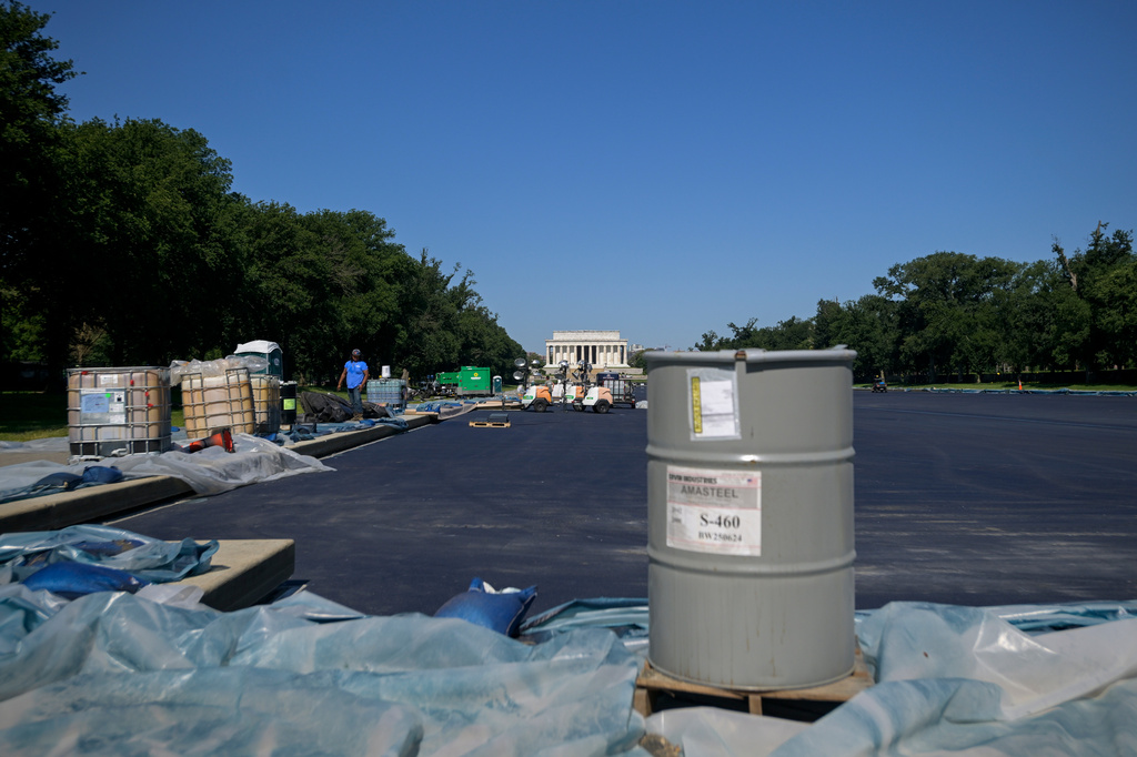 Work continues on the Lincoln Memorial Reflecting Pool, which is covered in a blue protective coating, ahead of the United States 250th anniversary, Thursday, June 4, 2026, in Washington. (AP Photo/Rod Lamkey, Jr.)