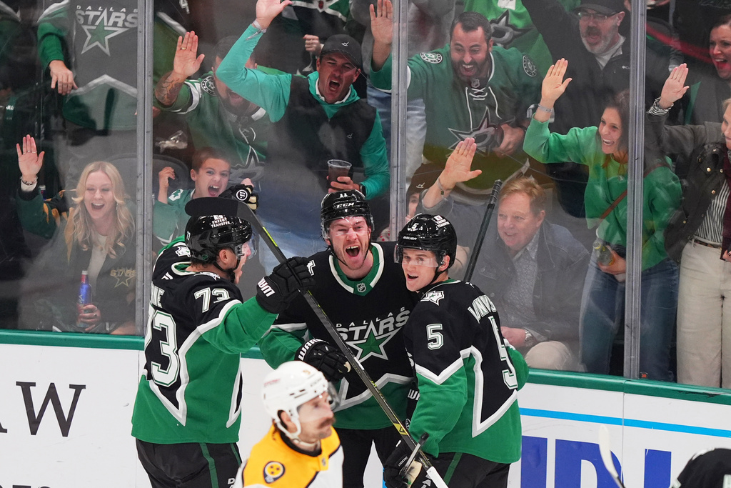 Dallas Stars right wing Nathan Bastian (11) celebrates his goal with teammates defenseman Nils Lundkvist (5) and left wing Adam Erne (73) during the third period of an NHL hockey game against the Nashville Predators Saturday, Feb. 28, 2026, in Dallas. (AP Photo/LM Otero)