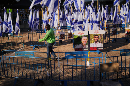 A worker cleans the ground at the plaza known as hostages square, in Tel Aviv, Israel, Tuesday, Oct. 14, 2025. (AP Photo/Francisco Seco) A worker cleans the ground at the plaza known as hostages square, in Tel Aviv, Israel, Tuesday, Oct. 14, 2025. (AP Photo/Francisco Seco)
