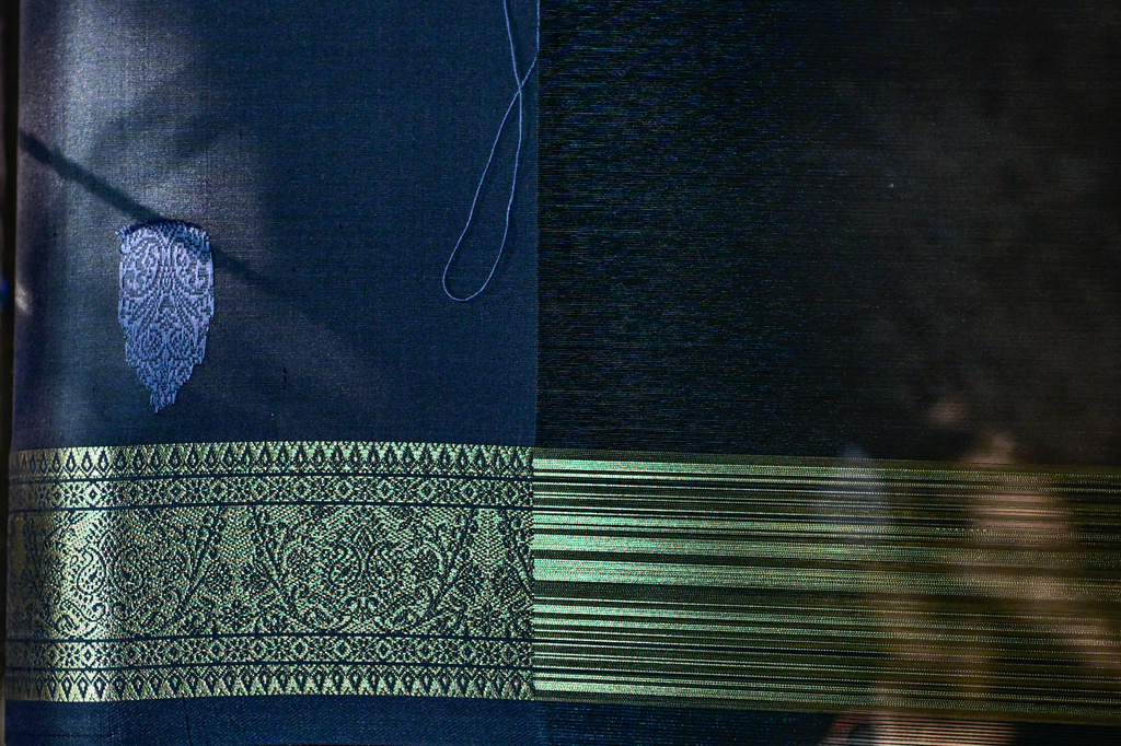 A Tangail saree takes shape on a loom at a traditional weaving workshop in Tangail District, Bangladesh, Nov. 5, 2025. (AP Photo/Mahmud Hossain Opu)