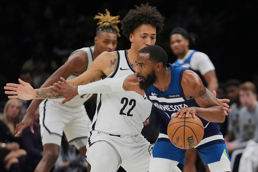 Brooklyn Nets' Jalen Wilson (22) defends Minnesota Timberwolves' Mike Conley (10) during the first half of an NBA basketball game Monday, Nov. 3, 2025, at Barclays Center in New York. (AP Photo/Frank Franklin II)