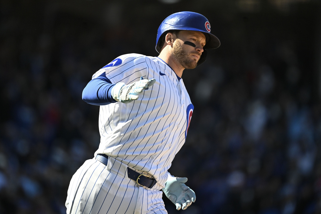 Chicago Cubs' Ian Happ rounds the bases after hitting a three-run home run delivers during the sixth inning of a baseball game against the Washington Nationals, Saturday, March 28, 2026, in Chicago. (AP Photo/Matt Marton)