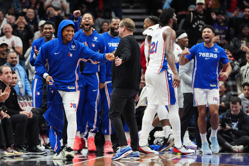 Philadelphia 76ers players cheer as teammate Kyle Lowry, front left, is brought into an NBA basketball game by head coach Nick Nurse, center, in the final minutes of second half against the Toronto Raptors in Toronto, Monday, Jan. 12, 2026. (Frank Gunn/The Canadian Press via AP)