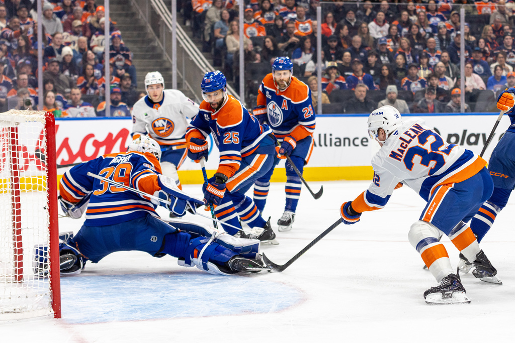 Edmonton Oilers goalie Connor Ingram (39) makes a save against New York Islanders' Kyle MacLean (32) during the first period of an NHL hockey game in Edmonton, Alberta, Thursday, Jan. 15, 2026. (Timothy Matwey/The Canadian Press via AP)