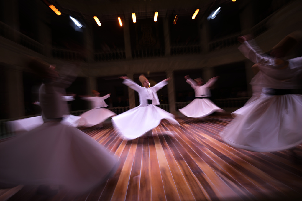 Whirling dervishes of the Mevlevi order perform during a Sheb-i Arus ceremony at Kasimpasa Mevlevihane in Istanbul, Turkey, Thursday, Dec. 11, 2025, to commemorate the death of 13th century Islamic scholar, poet and Sufi mystic Jalaladdin Rumi. (AP Photo/Francisco Seco)