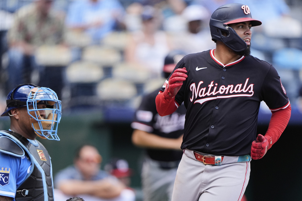 Washington Nationals' Luis Garcia Jr. crosses the plate to score on a single hit by Daylen Lile during the ninth inning of a baseball game against the Kansas City Royals, Wednesday, Aug. 13, 2025, in Kansas City, Mo. (AP Photo/Charlie Riedel)