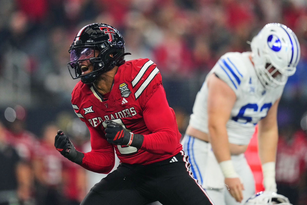 Texas Tech defensive end Romello Height celebrates a defensive stop against BYU in the first half of a Big 12 Conference championship NCAA college football game Saturday, Dec. 6, 2025, in Arlington, Texas. (AP Photo/Julio Cortez)