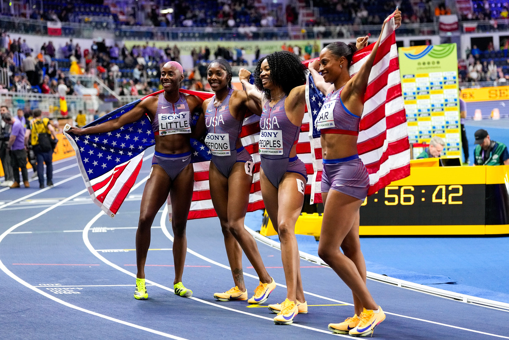 Team of the United States, from left to right, Shamier Little, Rosey Effiong, Paris Peoples, and Bailey Lear, pose for a photo after winning gold medals in the women's 4 X 400 meters relay final at the World Athletics Indoor Championships in Torun, Poland, Sunday, March 22, 2026. (AP Photo/Petr David Josek)