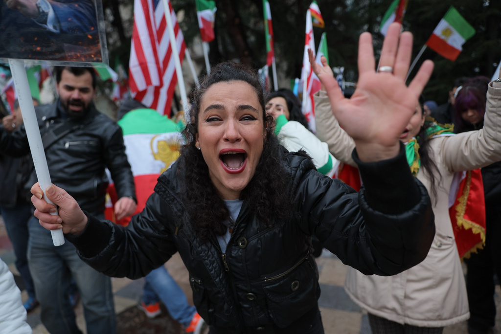Iranian people attend a demonstration in support of the U.S. and Israeli strikes on Iran, at the Iranian Embassy in Tbilisi, Georgia, Sunday, March 1, 2026. (AP Photo/Zurab Tsertsvadze)