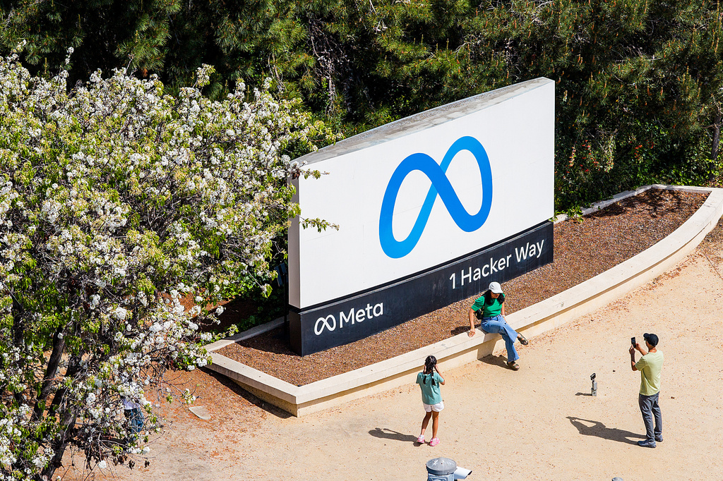 Visitors take photos at a sign outside Meta headquarters on Thursday, March 26, 2026, in Menlo Park, Calif. (AP Photo/Noah Berger)