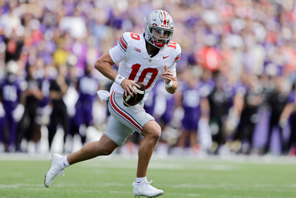 Ohio State quarterback Julian Sayin (10) scrambles against the Washington during the first half of an NCAA college football game, Saturday, Sept. 27, 2025, in Seattle. (AP Photo/John Froschauer)