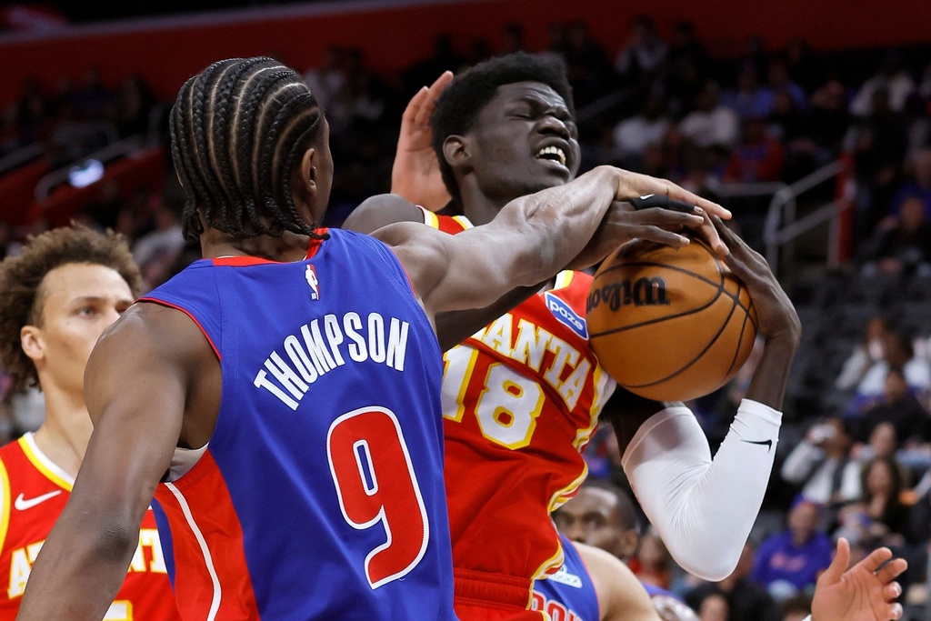 Atlanta Hawks forward Mouhamed Gueye (18) is defended by Detroit Pistons guard Ausar Thompson (9) while going to the basket during the first half of an NBA basketball game Friday, Dec. 12, 2025, in Detroit. (AP Photo/Duane Burleson)