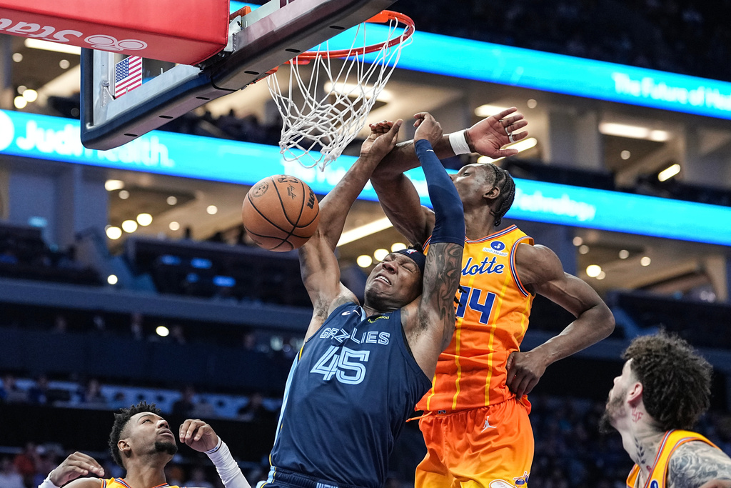 Memphis Grizzlies forward GG Jackson (45) drives past Charlotte Hornets forward Moussa Diabate (14) for a slam dunk during the second half of an NBA basketball game Saturday, March 21, 2026, in Charlotte, N.C. (AP Photo/Matt Kelley)