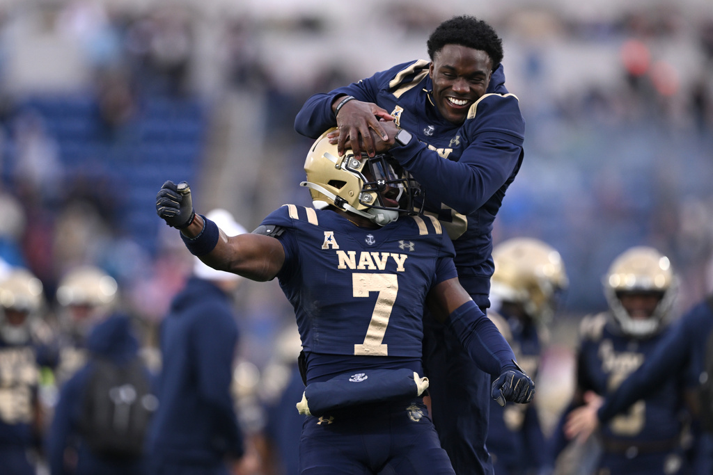 Navy safety Kush'I Abraham (7) celebrates after defeating South Florida in an NCAA college football game, Saturday, Nov. 15, 2025, in Annapolis, Md. (AP Photo/Gail Burton)