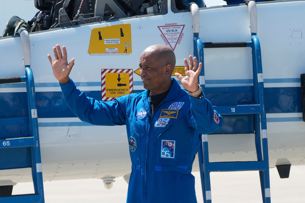 Artemis 2 crew member, Pilot Victor Glover, waves to the media after the crew's arrival at the Kennedy Space Center Friday, March 27, 2026, in Cape Canaveral, Fla. (AP Photo/Chris O'Meara)