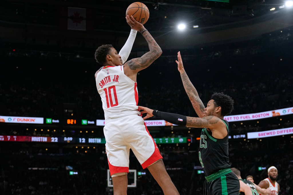Houston Rockets forward Jabari Smith Jr. (10) shoots over Boston Celtics guard Anfernee Simons (4) during the first half of an NBA basketball game, Saturday, Nov. 1, 2025, in Boston. (AP Photo/Charles Krupa)