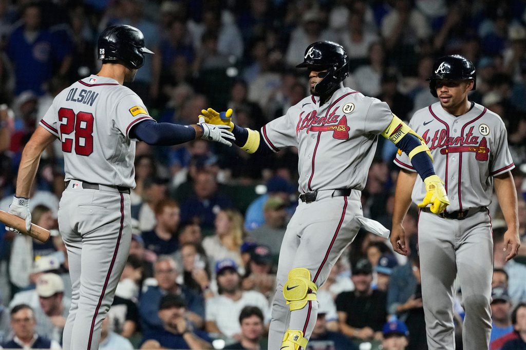 Atlanta Braves' Ronald Acu&ntilde;a Jr., center, celebrates with Matt Olson, left, and Drake Baldwin after hitting a two-run home run during the sixth inning of a baseball game against the Chicago Cubs in Chicago, Tuesday, Sept. 15, 2026. (AP Photo/Nam Y. Huh)