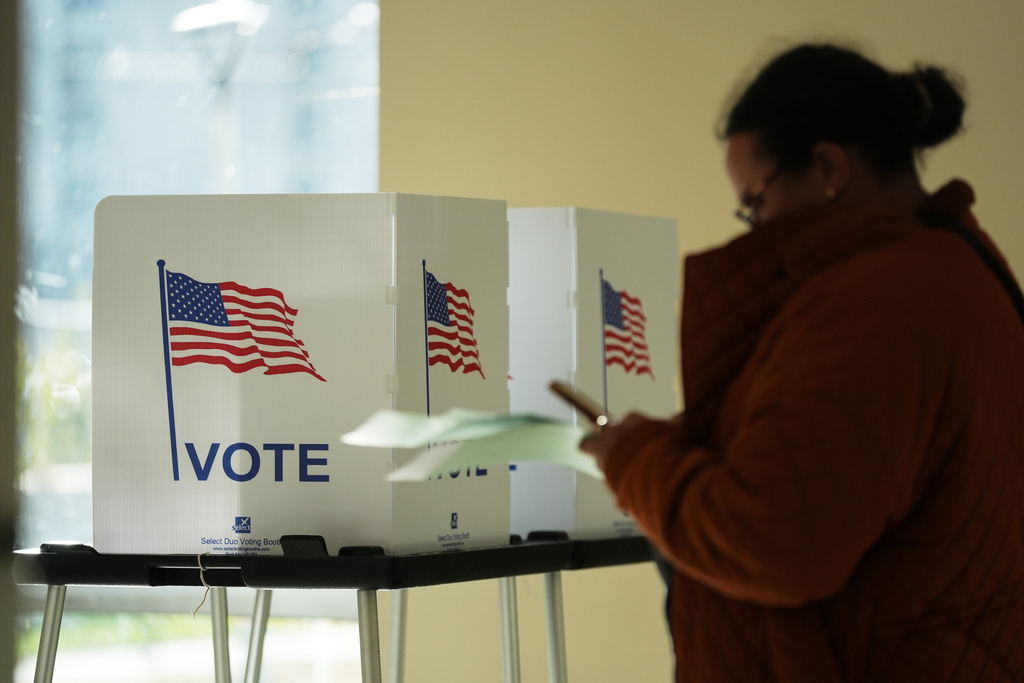 People wait to cast their ballot at the Horatio Williams Foundation in downtown Detroit, Tuesday, Nov. 4, 2025. (AP Photo/Ryan Sun)