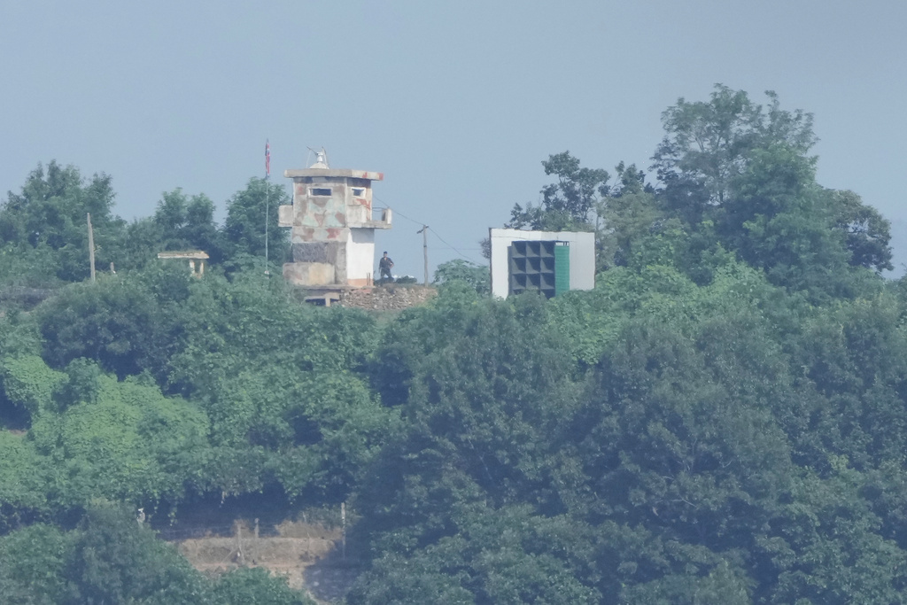 A North Korean military guard post, left, and loudspeaker are seen from Paju, South Korea, near the border with North Korea, Sunday, Aug. 10, 2025. (AP Photo/Ahn Young-joon)