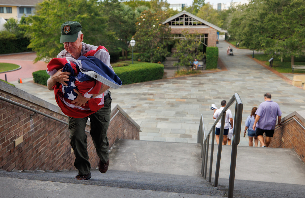 Park rangers spend the first morning of the government shutdown closing down the Fort Sumter National Monument center including taking down the American flag Wednesday, Oct. 1, 2025, in Charleston, S.C. (Grace Beahm Alford/The Post And Courier via AP)