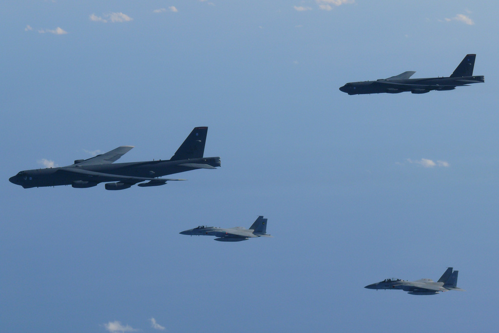 This photo provided by Japan's Ministry of Defense shows the Japan Air Self-Defense Force's F-15 fighters holding a joint military drill with the U.S. B-52 bombers in the vicinity of Japanese airspace on Wednesday Dec. 10, 2025. (Japan's Ministry of Defense via AP)