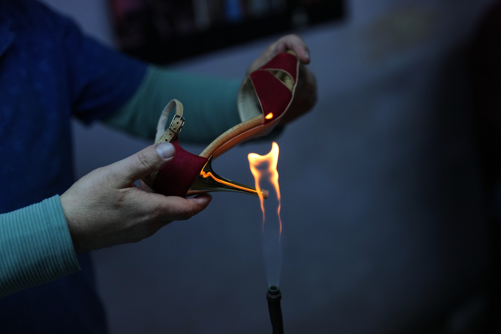 An employee works on crafting tango dance shoes at Necmi Usta's workshop in Istanbul. (AP Photo/Francisco Seco)