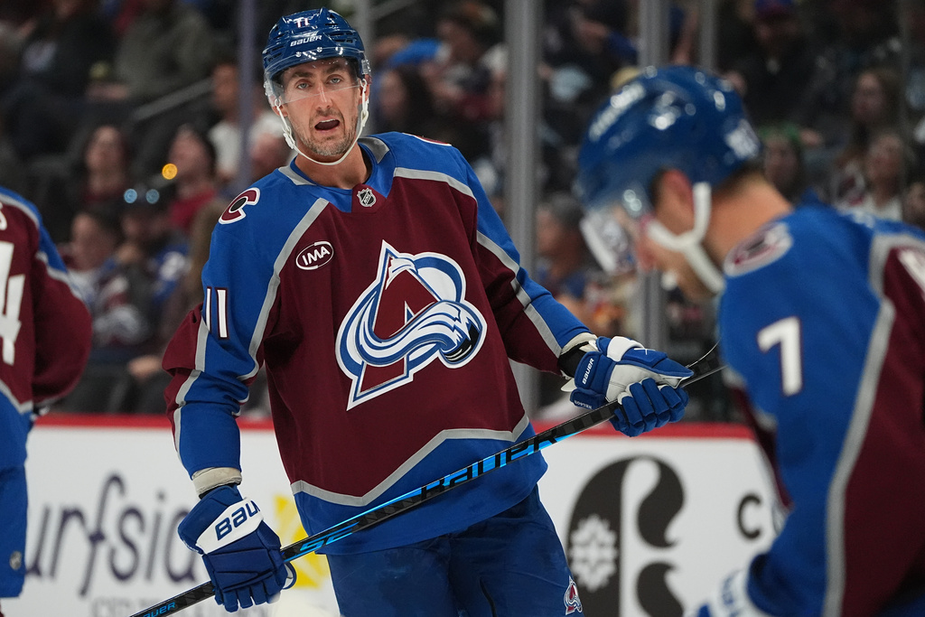 Colorado Avalanche center Brock Nelson, left, confers with defenseman Devon Toews (7) in the second period of an NHL hockey game against the Utah Mammoth, Thursday, Oct. 9, 2025, in Denver. (AP Photo/David Zalubowski)