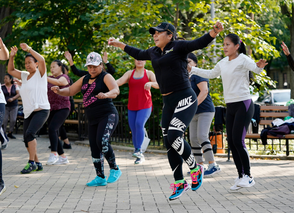 FILE - Yeni Salazar, center, leads a Zumba class in Queen's Elmhurst Memorial Park, Sept. 21, 2020, in New York. (AP Photo/Mark Lennihan, File)