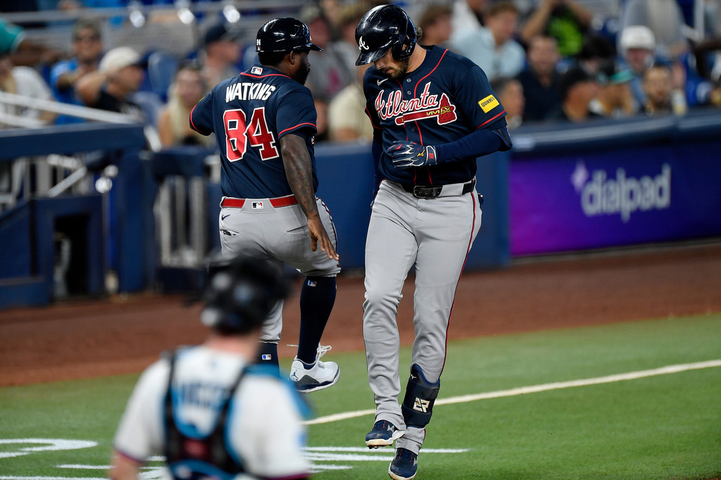 Atlanta Braves' Austin Riley, right, celebrates with third base coach Tommy Watkins (84) after hitting a home run during the second inning of a baseball game, Wednesday, May 20, 2026, in Miami. (AP Photo/Michael Laughlin)