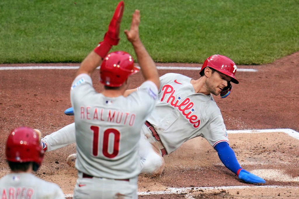 Philadelphia Phillies' Trea Turner, right, scores the second of two runs on a single by Kyle Schwarber off Pittsburgh Pirates pitcher Bubba Chandler during the second inning of a baseball game in Pittsburgh, Saturday, May 16, 2026. (AP Photo/Gene J. Puskar)