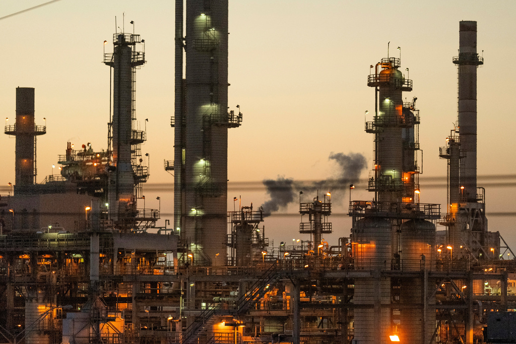 FILE - Lights illuminate an oil refinery in Carson, Calif., May 29, 2024. (AP Photo/Damian Dovarganes, File)