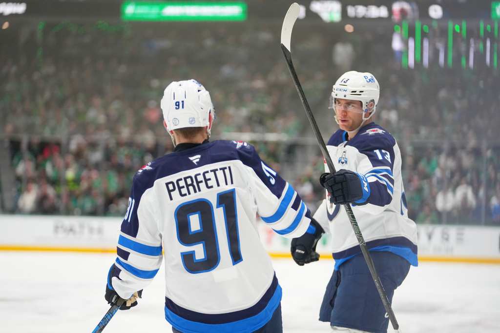 Winnipeg Jets center Gabriel Vilardi, right, celebrates his first period goal with center Cole Perfetti (91) during an NHL hockey game against the Dallas Stars Monday, Feb. 2, 2026, in Dallas. (AP Photo/Julio Cortez)