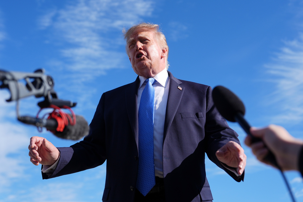 President Donald Trump speaks with reporters upon arriving at Chicago O'Hare International Airport, Sunday, Sept. 27, 2026, in Chicago. (AP Photo/Julia Demaree Nikhinson)
