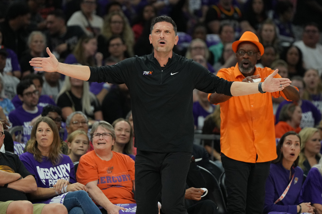 Phoenix Mercury head coach Nate Tibbetts reacts after a foul call against the Las Vegas Aces during the first half of Game 4 of the WNBA basketball finals, Friday, Oct. 10, 2025, in Phoenix. (AP Photo/Rick Scuteri)