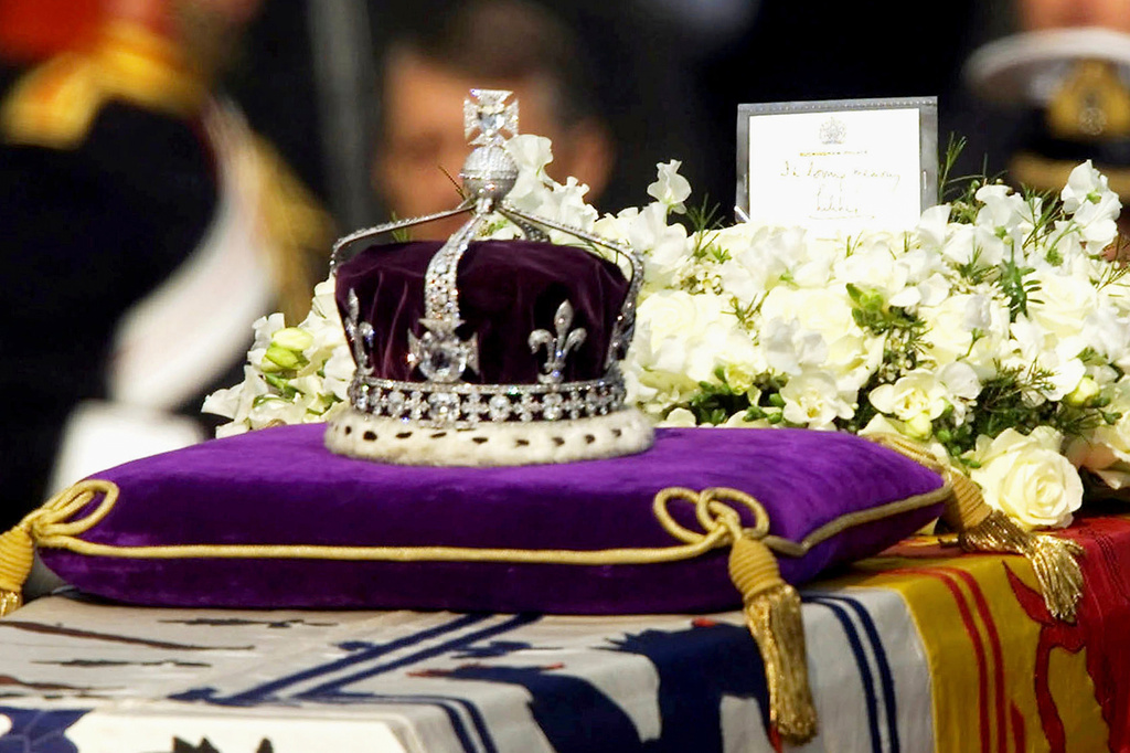 FILE - The Koh-i-Noor diamond, set in the Maltese Cross at the front of the crown made for Britain's late Queen Mother, is seen on her coffin as it is drawn to London's Westminster Hall on April 5, 2002. (AP Photo/Alastair Grant, File)
