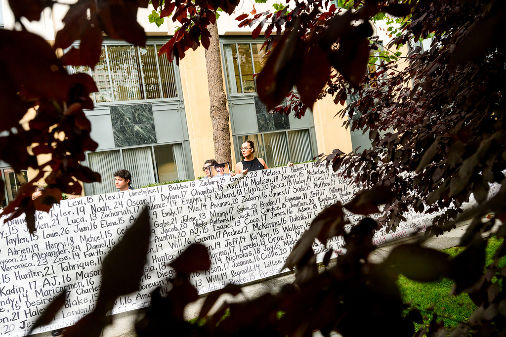 Lennon Torres of Heat Initiative holds a banner with names of young people who advocates say died as a result of social media outside the Ronald V. Dellums Federal Building and U.S. Courthouse on Tuesday, Aug. 18, 2026, in Oakland, Calif. (AP Photo/Noah Berger)