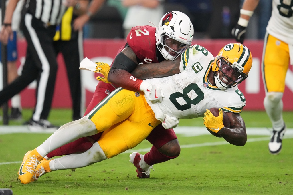 Arizona Cardinals' Mack Wilson stops Green Bay Packers' Josh Jacobs during the second half of an NFL football game Sunday, Oct. 19, 2025, in Glendale, Ariz. (AP Photo/Ross D. Franklin)